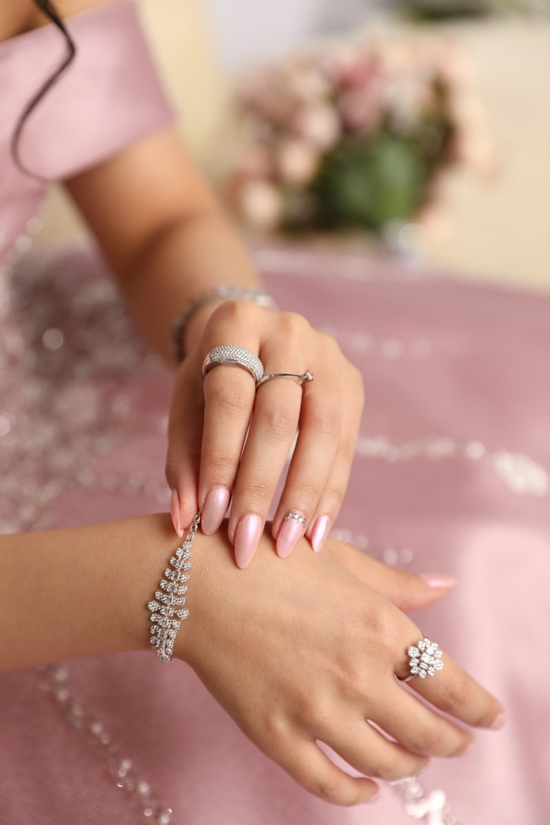 a woman in a pink dress holding onto a ring